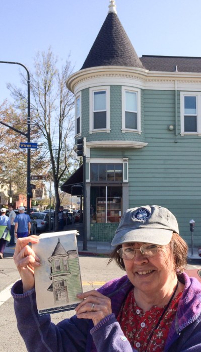 Carol holding her sketch of the corner of Shattuck and Vine